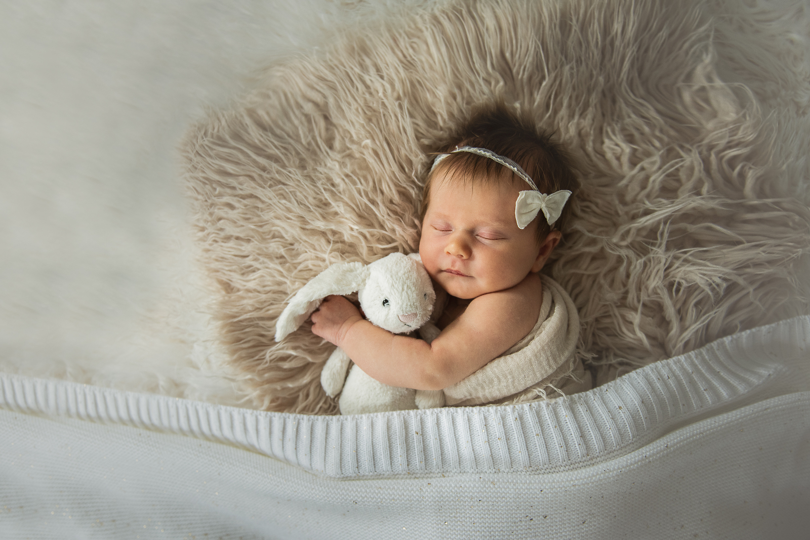 Decorative image of newborn baby girl with bunny