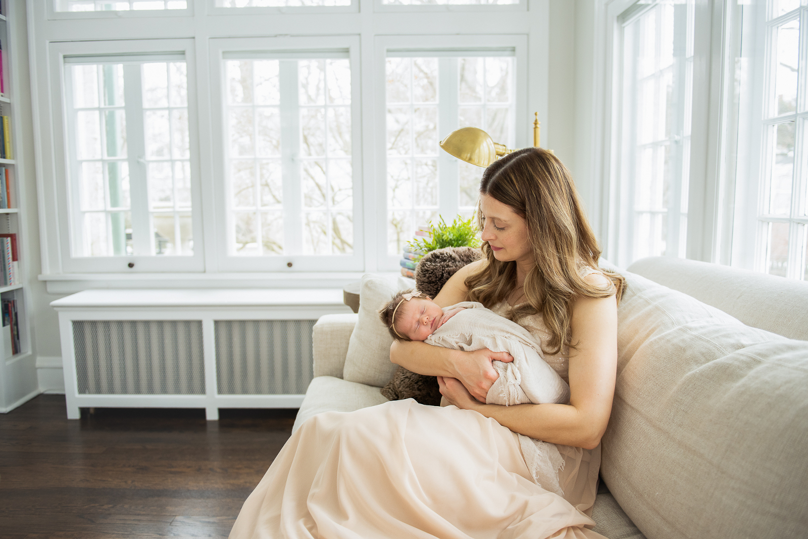 Mother and newborn in natural lit room